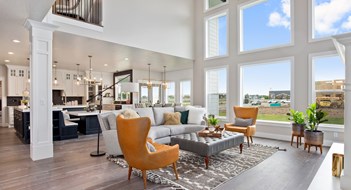 Home Staging Vinyl waterproof flooring in two story open great room with tall windows