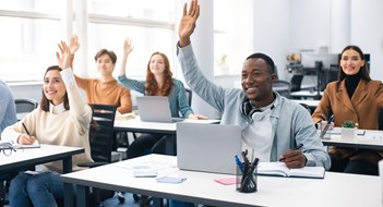 Presentation, Convention Concept. Portrait of smiling international people participating in seminar at modern office, raising hands up to ask question or to volunteer, diverse group sitting at tables