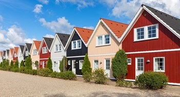 Row of almost identical wooden holiday cottages in Denmark