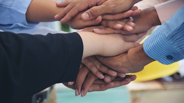 Partners hands together teamwork group of business people meeting in firm company office. Diversity Hands join empower partnership teams connection community. Success Mergers acquisitions partnership