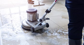 Sprucing Up for Spring Janitor use floor scrubber machine on the floor hallway office building or walkway after school and classroom work job with sun light background. Wet floor or cleaning service house maid concept.