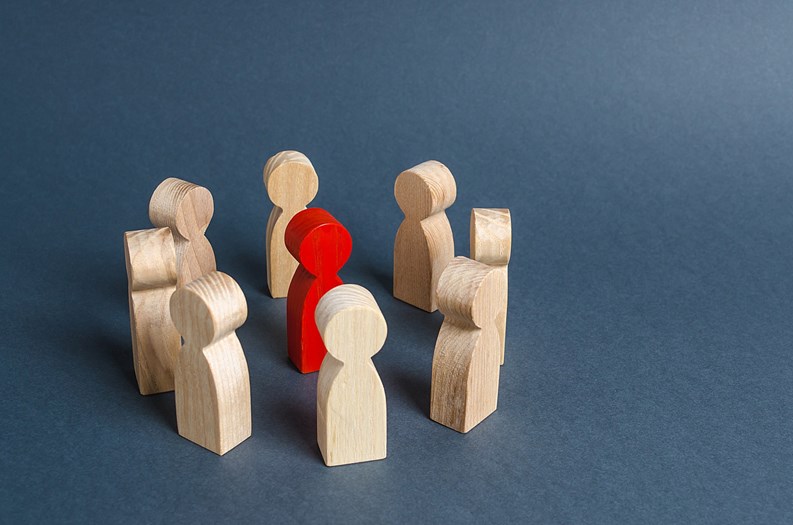 Red human figure surrounded by a circle of people. Leader Boss and leadership. Cooperation and teamwork. Outcast, hated opponent, criminal. Conviction. Discrimination and violence.