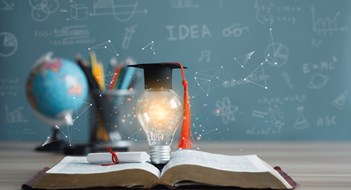 Continuing Education for Managers Graduation cap with a lightbulb on the book and globe in the classroom. Education learning concepts in school or university. Idea knowledge of innovative technology, science, and mathematics.