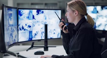 Surveillance & Security Watch, security and woman with radio, cctv and monitor for danger, talking and control room for guard. Desk, night and working for protection, safety and communication to backup and connection