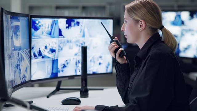 Watch, security and woman with radio, cctv and monitor for danger, talking and control room for guard. Desk, night and working for protection, safety and communication to backup and connection