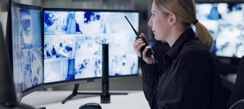 Watch, security and woman with radio, cctv and monitor for danger, talking and control room for guard. Desk, night and working for protection, safety and communication to backup and connection