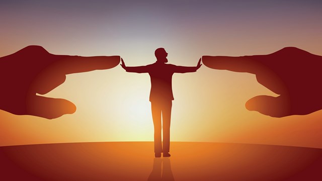 Concept of opposition with a man with his arms spread who symbolically repels two huge hands pointing at him to designate him as a scapegoat.