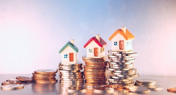 Increasing Homeowner Resale Values Miniature colorful house on stack coins using as property and financial concept
