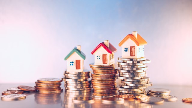 Miniature colorful house on stack coins using as property and financial concept