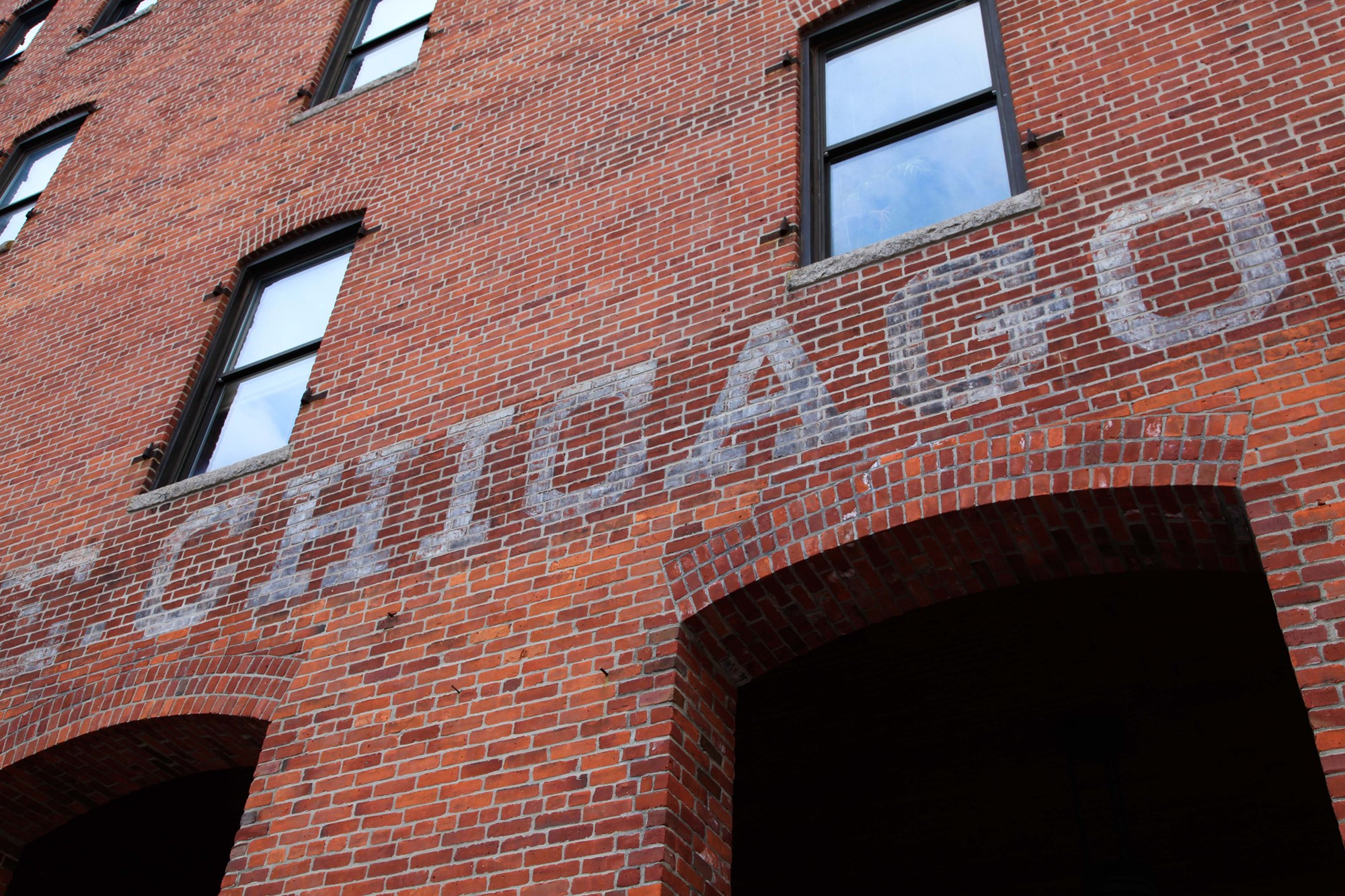 Chicago painted on brick wall in old fashioned style.