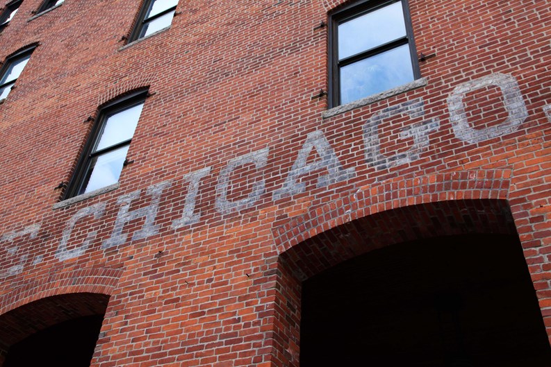 Chicago painted on brick wall in old fashioned style.